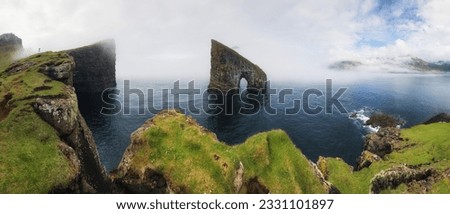 Faroe Island panorama with atlantic ocean and coast cliff, Drangarnir, Denmark