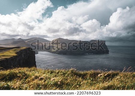 Similar – A big cloud hangs over a fjord