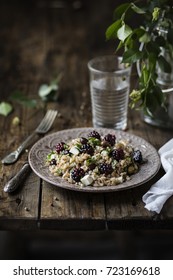 Farro Salad With Olives, Cheese And Blackberries On Rustic Wooden Table