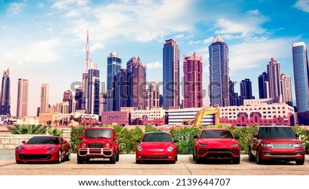 Fascinating cityscape with expensive luxury red cars in the parking lot against the backdrop of Dubai towers.