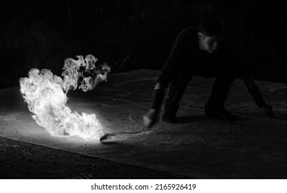 Fascinating And Dangerous. Man Manipulate With Burning Poi In Dark. Burning Fuel And Energy. Sparks And Lights. Night Show. Fire Performance. Flirt With Danger