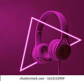 Fashinable headphones. 80's synth wave and retrowave glowing triangle futuristic aesthetics. Old fashioned abstraction concept