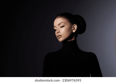 Fashion art studio portrait of beautiful elegant woman in black turtleneck. Hair high beam, perfect profile face. Elegant beauty style. Earrings in the ears - Shutterstock ID 2306976595
