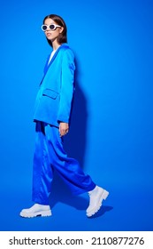 Fashion Asian Female Model In Blue Suit, White Boots And Sunglasses. Asian Fashion