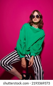 Fashion Asian Female Model In Green Trendy Sweater And Pants. Studio Shot