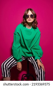 Fashion Asian Female Model In Green Trendy Sweater And Pants. Studio Shot