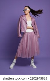 Fashion Asian Female Model. Lilac Leather Jacket, Lilac Skirt, White Boots, Sunglasses. Asian Fashion