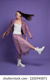 Fashion Asian Female Model. Lilac Leather Jacket, Lilac Skirt, White Boots, Sunglasses. Asian Fashion