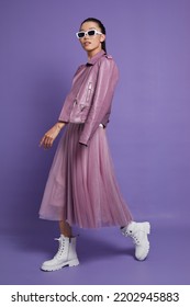 Fashion asian female model. Lilac leather jacket, lilac skirt, white boots, sunglasses. Asian fashion - Shutterstock ID 2202945883