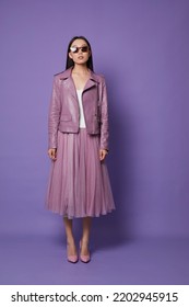 Fashion Asian Female Model. Lilac Leather Jacket, Lilac Skirt, Heels, Sunglasses. Asian Fashion