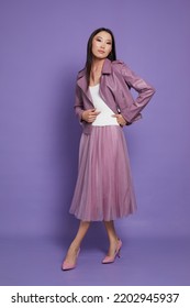 Fashion Asian Female Model. Lilac Leather Jacket, Lilac Skirt, Heels, Sunglasses. Asian Fashion