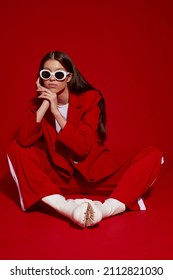 Fashion Asian Female Model In Red Suit, White Boots And Sunglasses. Asian Fashion