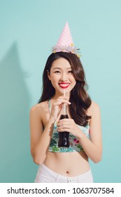 Fashion Asian Woman Drinks Coke Bottle Over Blue Background.