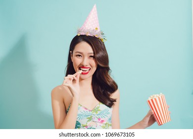 Fashion Asian Woman Drinks Coke Bottle Over Blue Background.