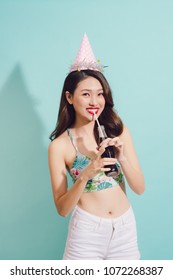 Fashion Asian Woman Drinks Coke Bottle Over Blue Background.