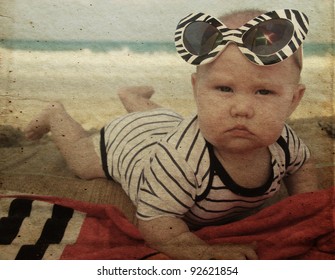 Fashion Baby On Seaside. Photo In Old Color Image Style.