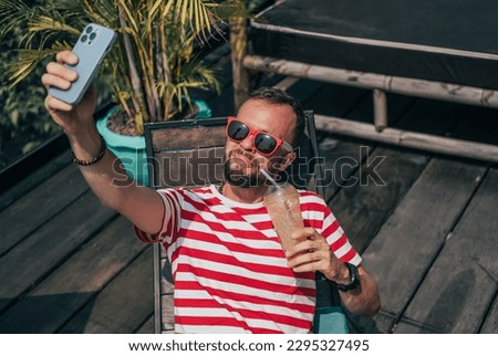 fashion beard man portrait, tattoo hand, Handsome beard using smartphone in hand, happy face, street photo, hipster style portrait, isolated, make video,instagram. facebook, villa, subbed,juice,selfie