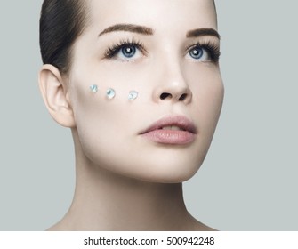 Fashion Beautiful Woman Face With Drops Of Gel On Another Cheek