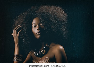 
Fashion Beauty Portrait Of A Beautiful Young Glamorous African Black Woman With Long Curly Hair Wearing Vintage Chic 70s Style Clothes And A Necklace