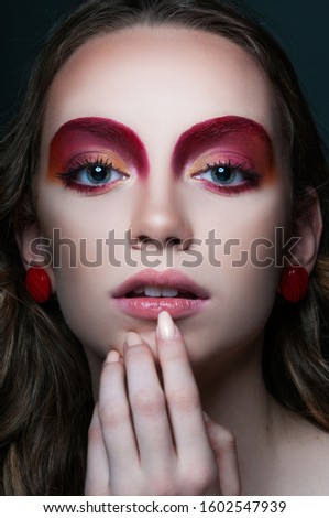 fashion beauty portrait of model with modern vogue trendy make up, magazine editorial ready, close up red eye shadows and lipstick, n studio 