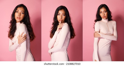 Fashion Beauty Woman Has Long Curl Black Hair Looks At Camera And Express Feeling Smile Happy. Portrait Of Asian Girl Show Tanned Skin Wear Pink Skinny Dress Over Pink Color Block Background