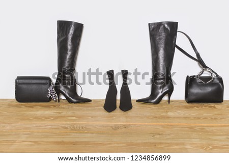 fashion black women's high heels,leather handbag on wooden background
