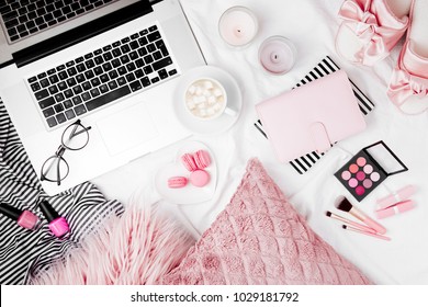 Fashion blogger workspace with laptop and woman accessory in bed. flat lay,  top view