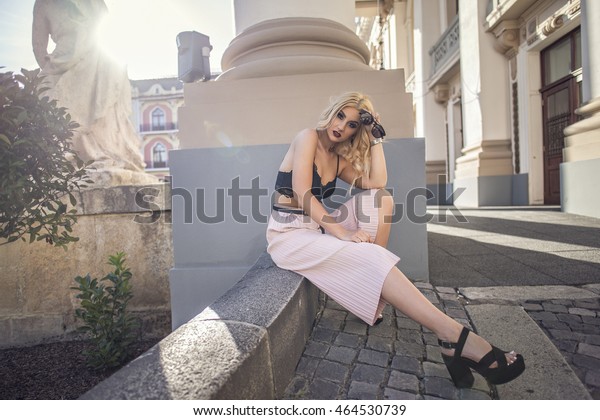Fashion blonde woman street style posing wearing sexy\
crop top