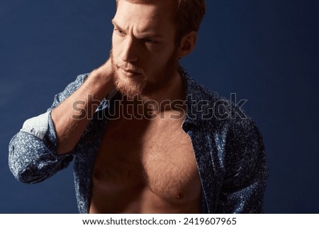 Fashion, body or model with muscle in studio on a blue background wearing an open unbuttoned shirt. Thinking, chest or handsome male person posing on color wall for masculine style, health or fitness Foto d'archivio © 