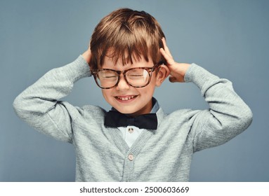 Fashion, bow tie and kid in studio with glasses for thinking, problem solving and ideas. Intelligent nerd, genius and isolated young boy with excited, happy and smile for knowledge on gray background - Powered by Shutterstock