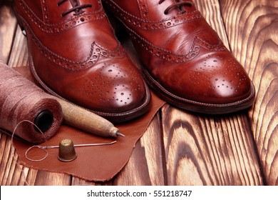 Fashion Brogues Shoes Handmade And Shoemaker Tools Hammer, Awl, Nails, Skien Of Thread .Wooden Background.Concept Cobbler Tools.copy Space