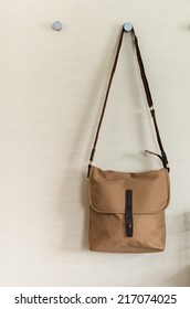 fashion brown shoulder bag hang on wall