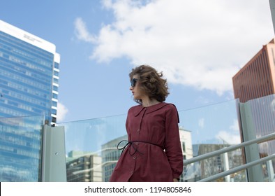 Fashion Businesswoman Walking In The City. City Woman. City Girl. Trend Setter. Celebrity Status. Busy Woman. Smart Businesswoman Overlooking Commercial Real Estate View. Urban Female. 