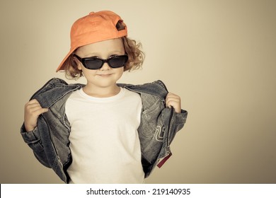 Fashion Child. Happy Boy Model. Stylish Little Boy In Baseball.  Handsome  Kid  In The Jeans Jacket.