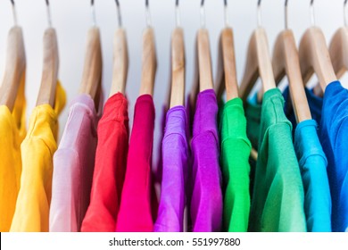 Fashion clothes on clothing rack - bright colorful closet. Closeup of rainbow color choice of trendy female wear on hangers in store closet or spring cleaning concept. Summer home wardrobe. - Shutterstock ID 551997880