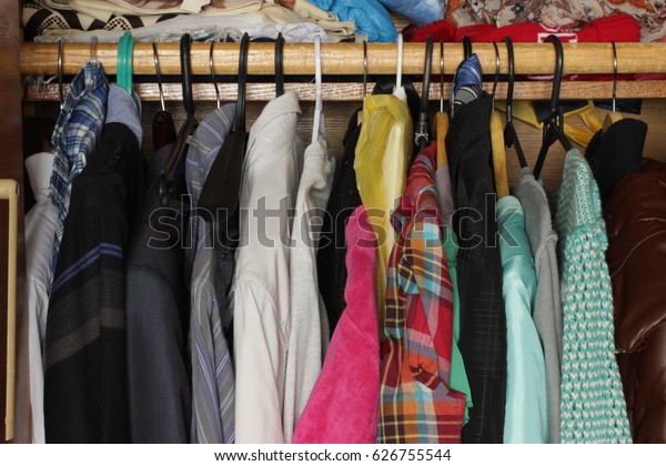Fashion clothes on clothing rack.  Summer\
home wardrobe. Colorful clothes in the\
closet.