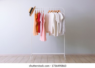 fashion clothes on a rack in a light background indoors. place for text - Shutterstock ID 1736490863
