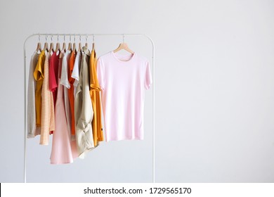 fashion clothes on a stand in a light background indoors. place for text
				