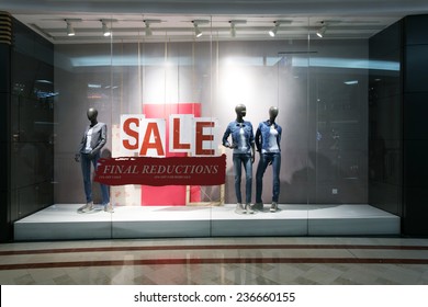 Fashion Clothes Shop Display Window And Sale Sign.