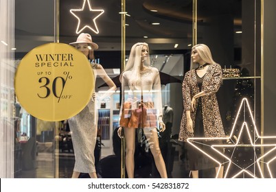 fashion clothes shop display window and sale sign