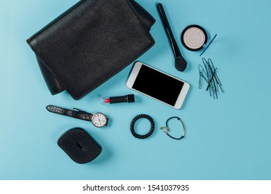 Fashion concept : Flat lay of brown leather woman bag open out with cosmetics, accessories and smartphone on pink background - Shutterstock ID 1541037935
