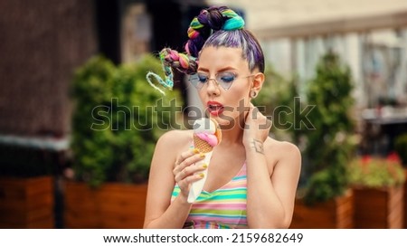 Fashion cool girl eating ice cream on street during summer vacation
