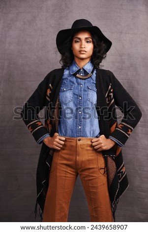 Fashion, cowgirl or woman confidence in portrait, studio and cool culture or clothing on grey background. Native American person, western and stylish model with pride, boho style and hands on hips