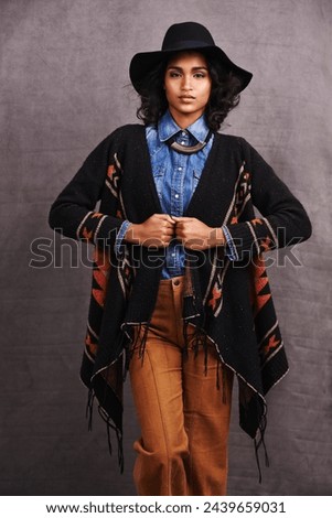 Fashion, cowgirl or woman with confidence in portrait, studio or cool clothing in culture on grey background. Native American person, unique or stylish model with pride, boho style or western poncho