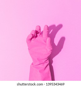 Fashion creative concept with hand in pink rubber glove, showing gesture. Aesthetic abstract minimalism.  - Shutterstock ID 1395343469