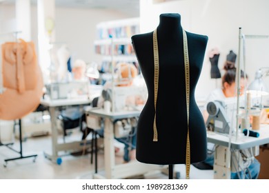 Fashion creative design studio interior concept with mannequin dummy and stylish fashionable trendy clothes on hangers, dressmaking workplace, tailor shop, sewing workshop - Shutterstock ID 1989281369