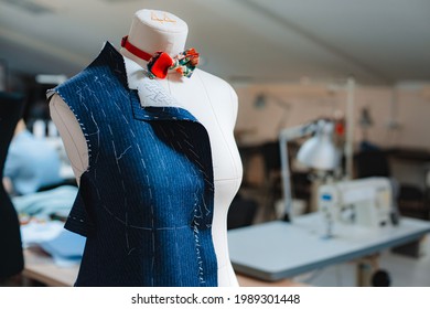 Fashion creative design studio interior concept with mannequin dummy and stylish fashionable trendy clothes on hangers, dressmaking workplace, tailor shop, sewing workshop