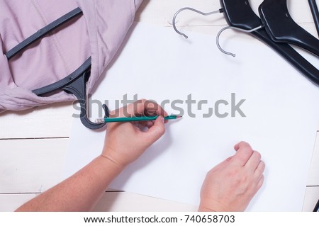 Fashion design sketch. Close up design. Sewing dresses and items for sewing. Sew clothes according to sketches. Centimeter tape, scissors, pattern, thread, hanger
