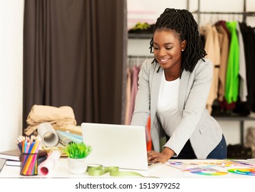 Fashion Design Software. African American Dressmaker Using Laptop Working On New Clothing Line In Showroom. Copy Space