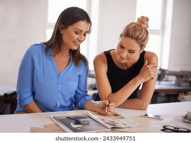 Fashion designer, collaboration and magazine for planning of ideas, teamwork and creative inspiration in workshop. Women or worker with print book, catalog and choice for style or clothes production - Powered by Shutterstock